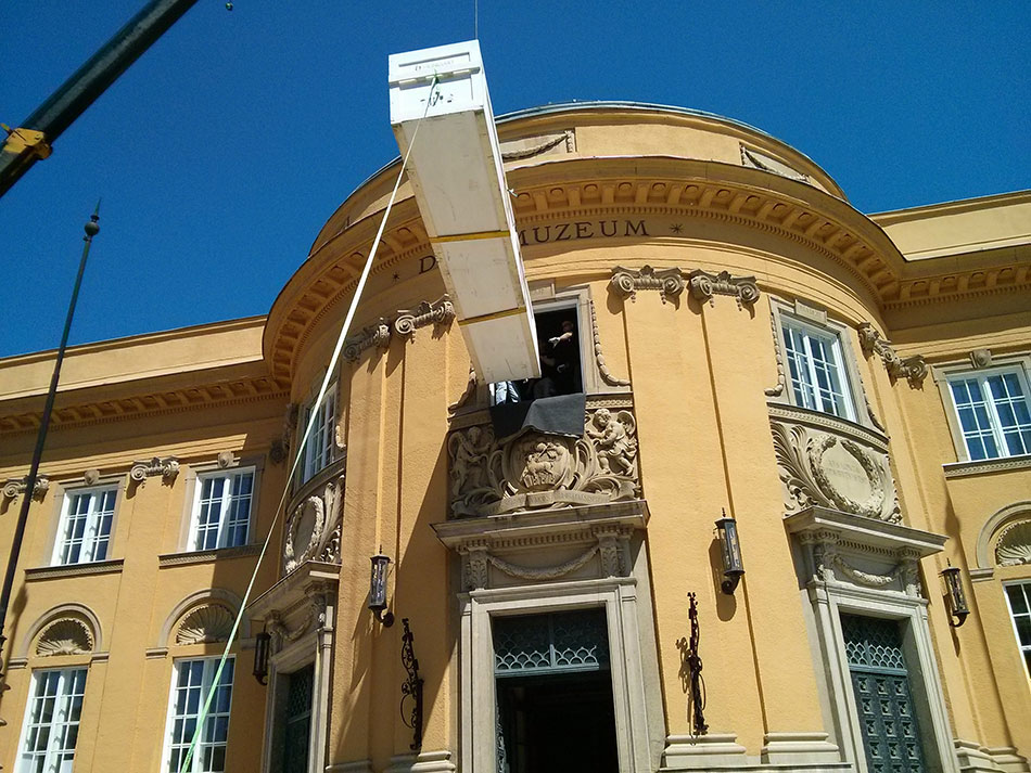 Loading the crate into the museum through a window.